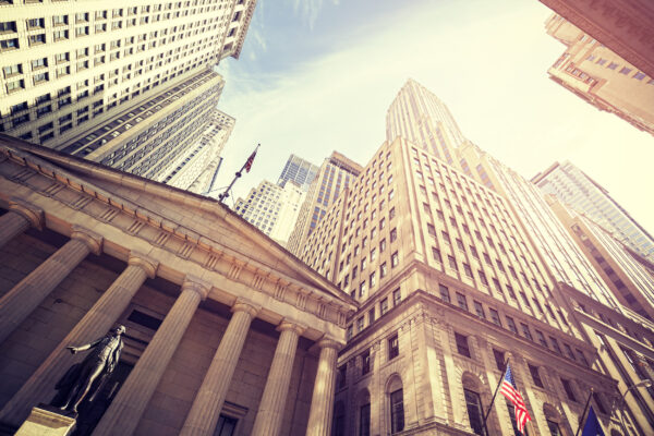 Vintage toned Wall Street at sunset, Manhattan, New York City, USA.